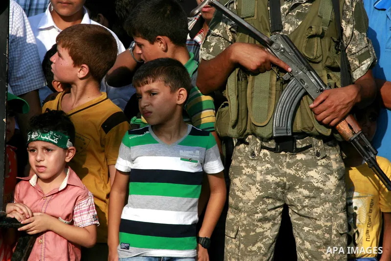 Members of Ezzedin al-Qassam Brigades, the armed wing of Hamas movement, take part in a graduation ceremony of a military-style camp organized by the Hamas movement in Khan Younis in the southern Gaza Strip, on August 5,...