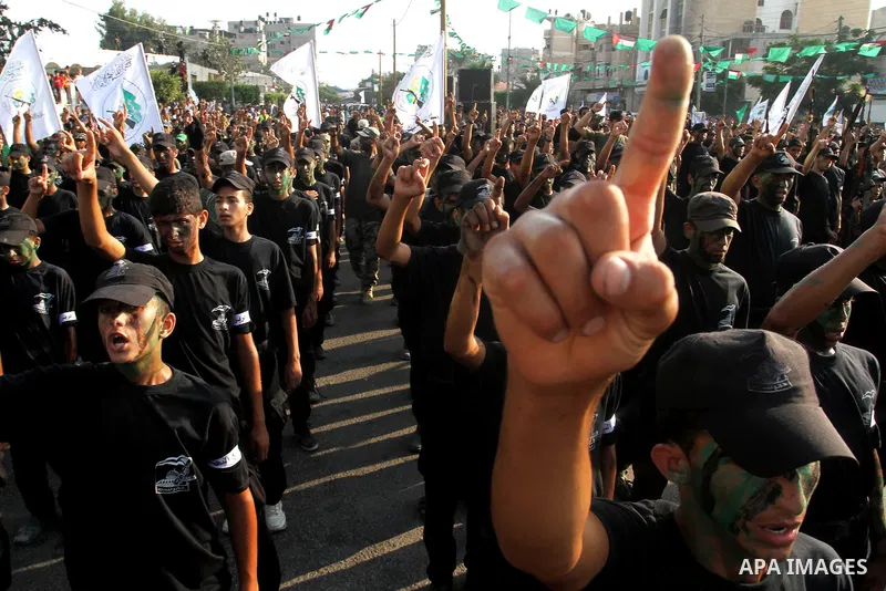 Palestinian youths take part in a graduation ceremony of a military-style camp organized by the Hamas movement in Khan Younis in the southern Gaza Strip, on August 5, 2015. Hamas's armed wing organized ''Liberation Youth...