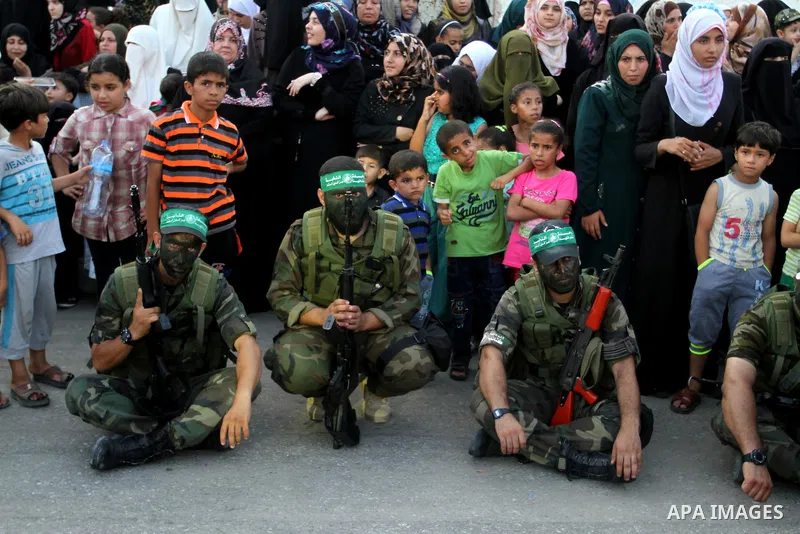 Members of Ezzedin al-Qassam Brigades, the armed wing of Hamas movement, take part in a graduation ceremony of a military-style camp organized by the Hamas movement in Khan Younis in the southern Gaza Strip, on August 5,...