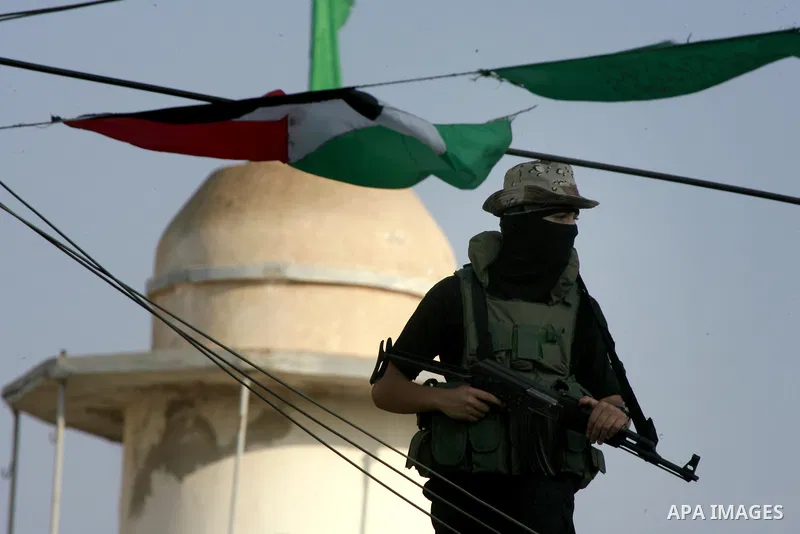 Members of Ezzedin al-Qassam Brigades, the armed wing of Hamas movement, take part in a graduation ceremony of a military-style camp organized by the Hamas movement in Khan Younis in the southern Gaza Strip, on August 5,...