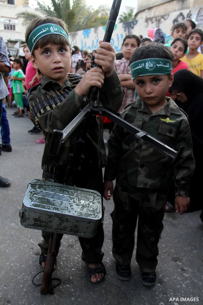 Palestinian children attend a graduation ceremony of a military-style camp organized by the Hamas movement in Khan Younis in the southern Gaza Strip, on August 5, 2015. Hamas's armed wing organized ''Liberation Youths Ca...