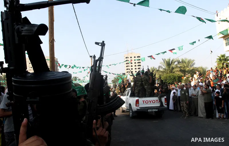 Members of Ezzedin al-Qassam Brigades, the armed wing of Hamas movement, take part in a graduation ceremony of a military-style camp organized by the Hamas movement in Khan Younis in the southern Gaza Strip, on August 5,...