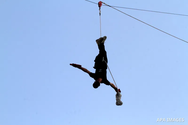 A Palestinian youth demonstrates his skills during a graduation ceremony of a military-style camp organized by the Hamas movement in Khan Younis in the southern Gaza Strip, on August 5, 2015. Hamas's armed wing organized...