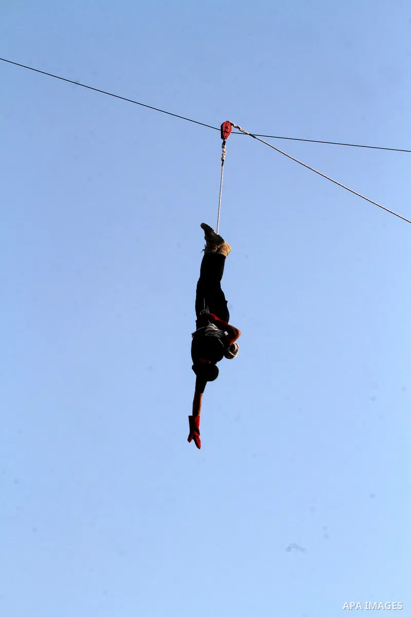 A Palestinian youth demonstrates his skills during a graduation ceremony of a military-style camp organized by the Hamas movement in Khan Younis in the southern Gaza Strip, on August 5, 2015. Hamas's armed wing organized...