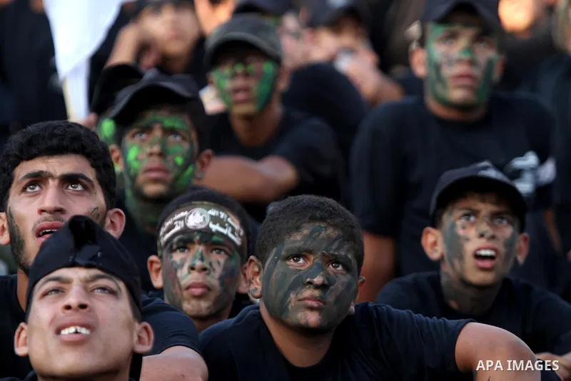 Palestinian youths take part in a graduation ceremony of a military-style camp organized by the Hamas movement in Khan Younis in the southern Gaza Strip, on August 5, 2015. Hamas's armed wing organized ''Liberation Youth...