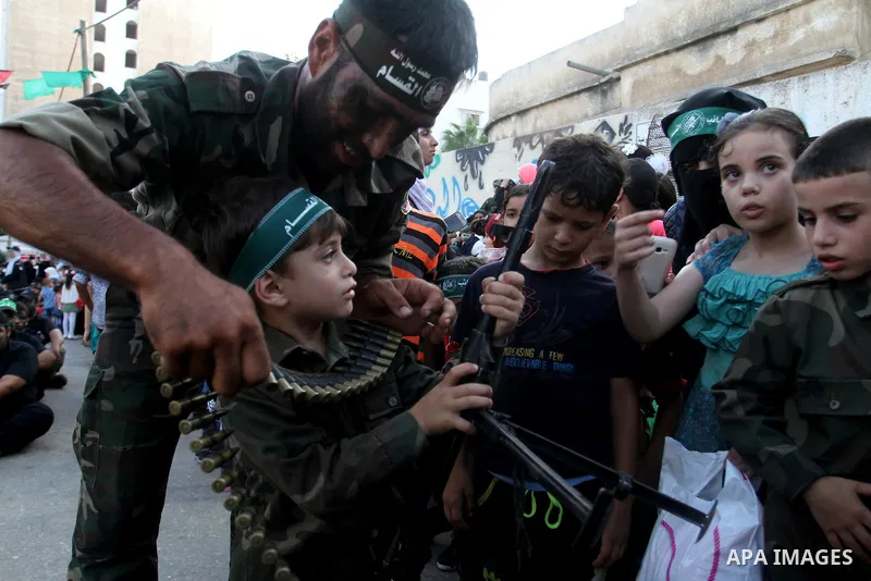 Palestinian children attend a graduation ceremony of a military-style camp organized by the Hamas movement in Khan Younis in the southern Gaza Strip, on August 5, 2015. Hamas's armed wing organized ''Liberation Youths Ca...