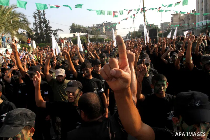 Palestinian youths take part in a graduation ceremony of a military-style camp organized by the Hamas movement in Khan Younis in the southern Gaza Strip, on August 5, 2015. Hamas's armed wing organized ''Liberation Youth...