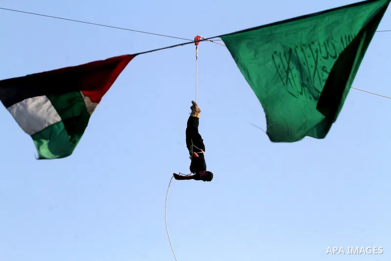 A Palestinian youth demonstrates his skills during a graduation ceremony of a military-style camp organized by the Hamas movement in Khan Younis in the southern Gaza Strip, on August 5, 2015. Hamas's armed wing organized...