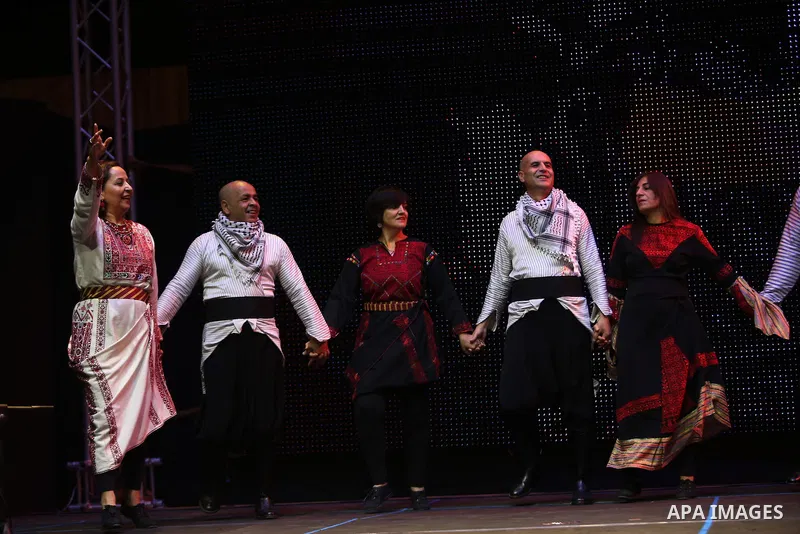 Dancers of Palestinian popular art troupe perform during the second night of the 16th Palestine International Dance Festival in the West Bank city of Ramallah on Aug. 5, 2015. Photo by Shadi Hatem