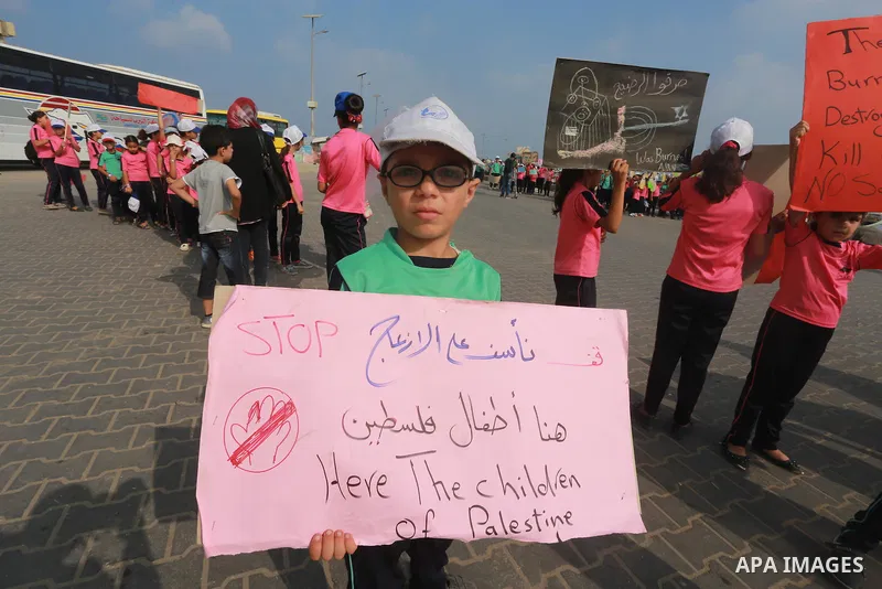 Palestinian childern take part a protest against the killing of 18-month-old Palestinian Ali Saad Dawabsheh, the toddler who was burned to death by suspected Jewish extremists, at the Seaport of Gaza city, on August 6, 2...