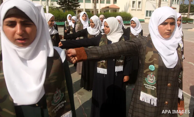 Palestinian girls perform exercises during a summer camp, organised by the Hamas movement, in Deir al-Balah in the center of Gaza Strip August 6, 2015. Photo by Ashraf Amra
