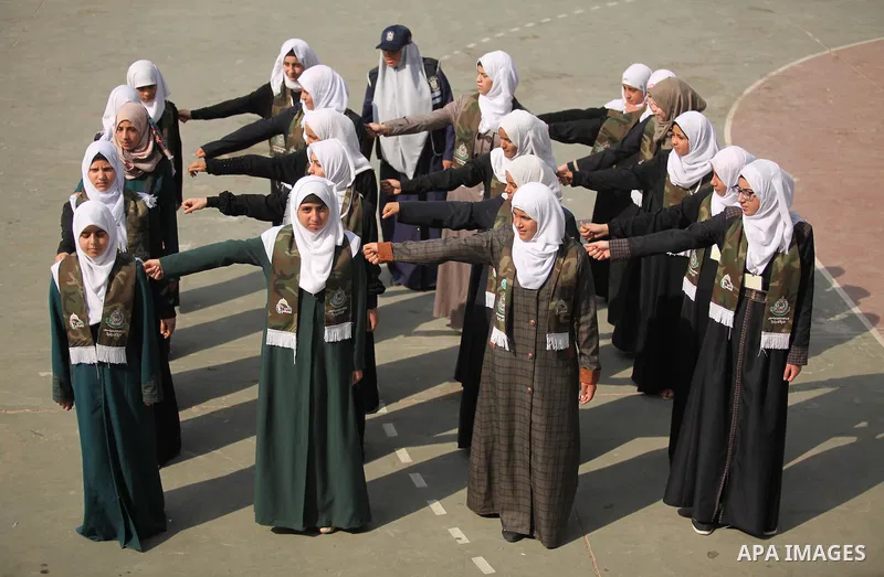 Palestinian girls perform exercises during a summer camp, organised by the Hamas movement, in Deir al-Balah in the center of Gaza Strip August 6, 2015. Photo by Ashraf Amra