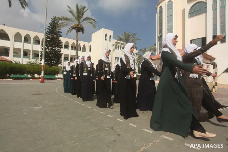 Palestinian girls perform exercises during a summer camp, organised by the Hamas movement, in Deir al-Balah in the center of Gaza Strip August 6, 2015. Photo by Ashraf Amra