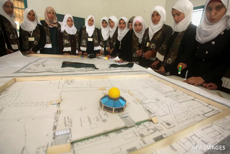 Palestinian girls perform exercises during a summer camp, organised by the Hamas movement, in Deir al-Balah in the center of Gaza Strip August 6, 2015. Photo by Ashraf Amra