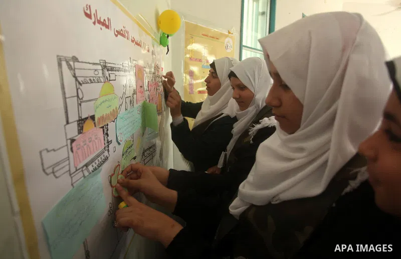 Palestinian girls perform exercises during a summer camp, organised by the Hamas movement, in Deir al-Balah in the center of Gaza Strip August 6, 2015. Photo by Ashraf Amra