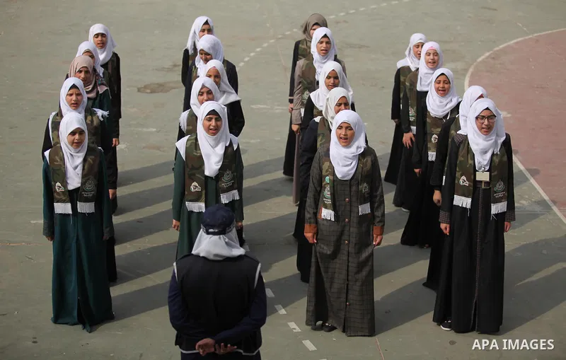 Palestinian girls perform exercises during a summer camp, organised by the Hamas movement, in Deir al-Balah in the center of Gaza Strip August 6, 2015. Photo by Ashraf Amra