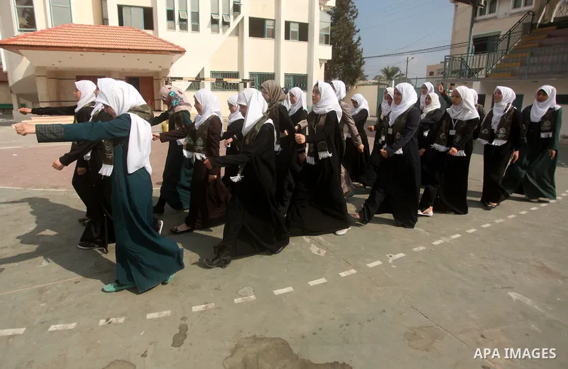 Palestinian girls perform exercises during a summer camp, organised by the Hamas movement, in Deir al-Balah in the center of Gaza Strip August 6, 2015. Photo by Ashraf Amra