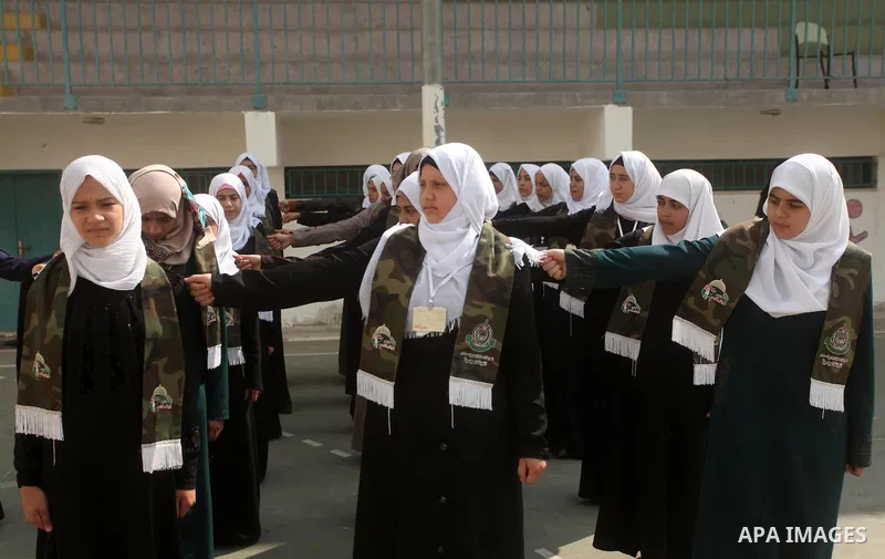 Palestinian girls perform exercises during a summer camp, organised by the Hamas movement, in Deir al-Balah in the center of Gaza Strip August 6, 2015. Photo by Ashraf Amra