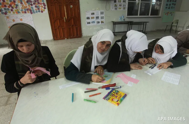 Palestinian girls perform exercises during a summer camp, organised by the Hamas movement, in Deir al-Balah in the center of Gaza Strip August 6, 2015. Photo by Ashraf Amra