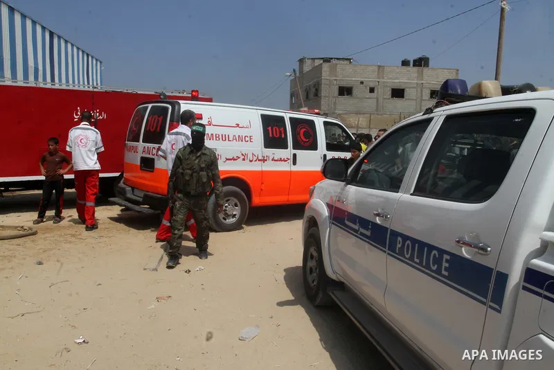 Members of the Ezzedine al-Qassam brigades, the armed wing of the Hamas movement, secure the area following an explosion that ripped through a house in the Al-Shabura refugee camp near the southern Gaza Strip town of Raf...