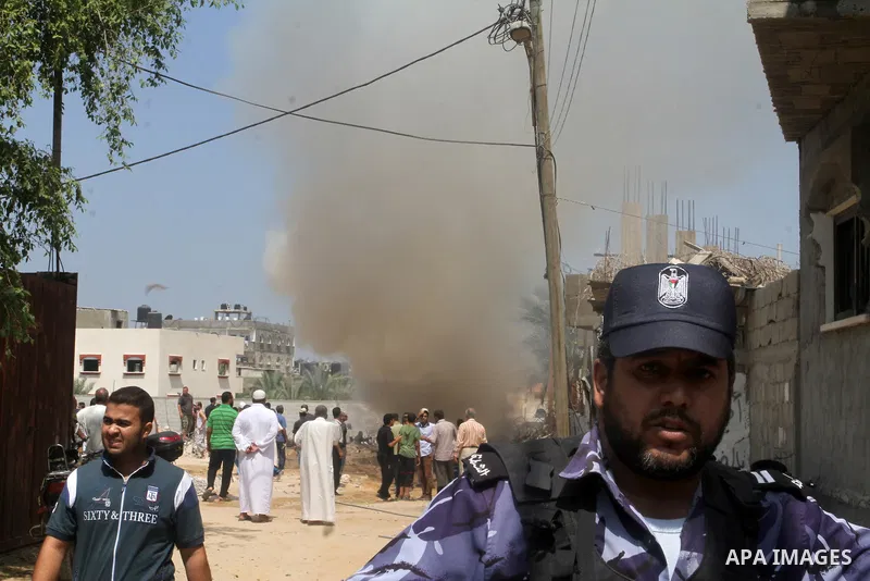 Members of the Ezzedine al-Qassam brigades, the armed wing of the Hamas movement, secure the area following an explosion that ripped through a house in the Al-Shabura refugee camp near the southern Gaza Strip town of Raf...