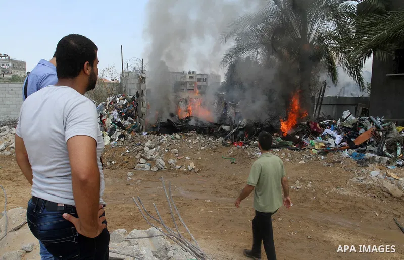 Palestinians gather at the site of an explosion that ripped through a house in the Al-Shabura refugee camp near the southern Gaza Strip town of Rafah on August 6, 2015. The blast killed at least two people and wounded 20...
