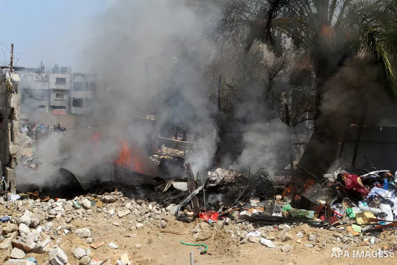 Palestinians gather at the site of an explosion that ripped through a house in the Al-Shabura refugee camp near the southern Gaza Strip town of Rafah on August 6, 2015. The blast killed at least two people and wounded 20...