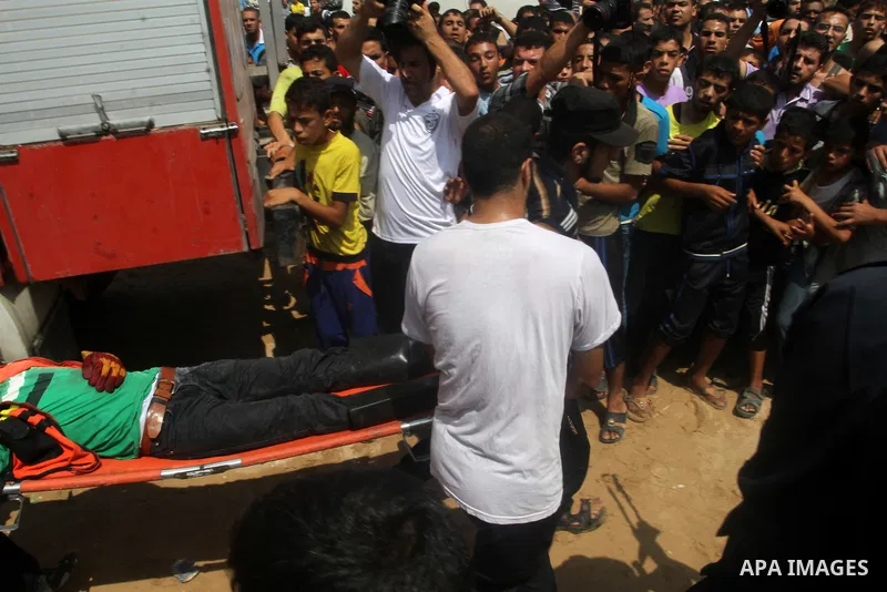 Palestinian emergency personnel carry an injured man following an explosion that ripped through a house in the Al-Shabura refugee camp near the southern Gaza Strip town of Rafah on August 6, 2015. The blast killed at lea...