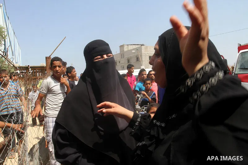 Palestinians gather at the site of an explosion that ripped through a house in the Al-Shabura refugee camp near the southern Gaza Strip town of Rafah on August 6, 2015. The blast killed at least two people and wounded 20...