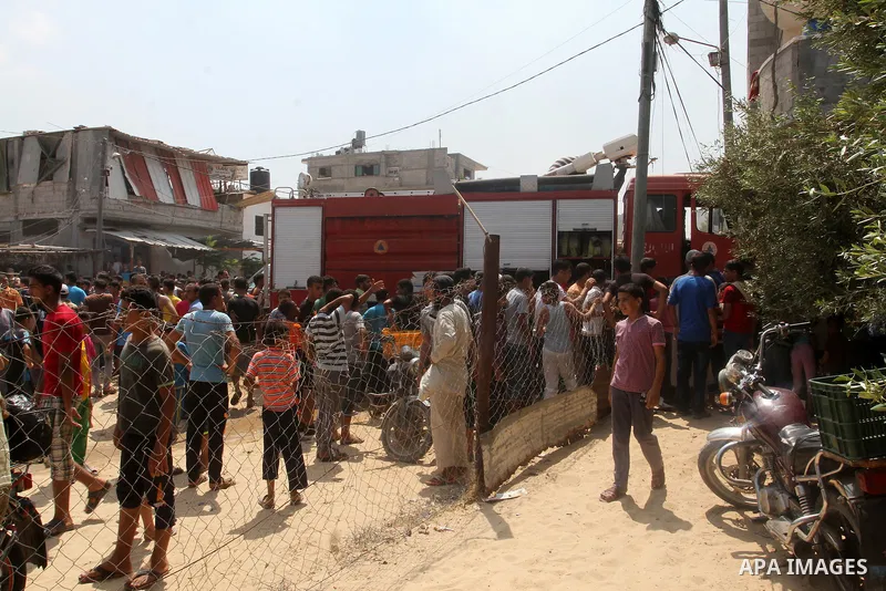 Palestinians gather at the site of an explosion that ripped through a house in the Al-Shabura refugee camp near the southern Gaza Strip town of Rafah on August 6, 2015. The blast killed at least two people and wounded 20...