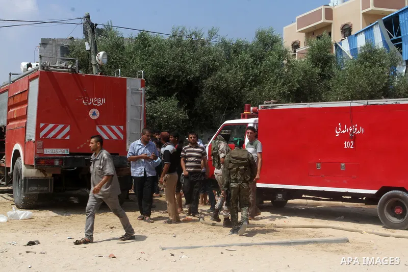 Palestinians gather at the site of an explosion that ripped through a house in the Al-Shabura refugee camp near the southern Gaza Strip town of Rafah on August 6, 2015. The blast killed at least two people and wounded 20...