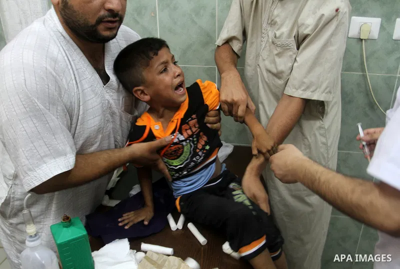 A Palestinian boy is treated at a hospital in the southern Gaza Strip town of Rafah following an explosion that ripped through a house in the nearby Al-Shabura refugee camp on August 6, 2015. The blast killed at least tw...