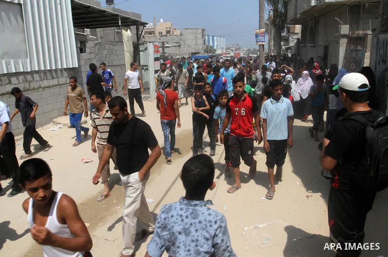 Palestinians gather at the site of an explosion that ripped through a house in the Al-Shabura refugee camp near the southern Gaza Strip town of Rafah on August 6, 2015. The blast killed at least two people and wounded 20...