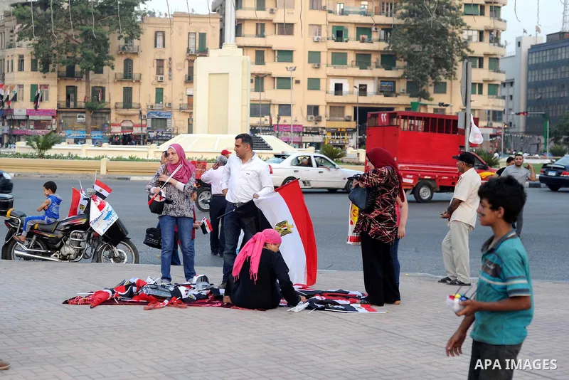 Supporter of Egyptian President Abdel-Fattah el-Sissi celebrate for Thursday's opening of the new extension of the Suez Canal, in cairo, Egypt, Thursday, Aug. 6, 2015. Egypt is to unveil a major extension of the Suez Can...