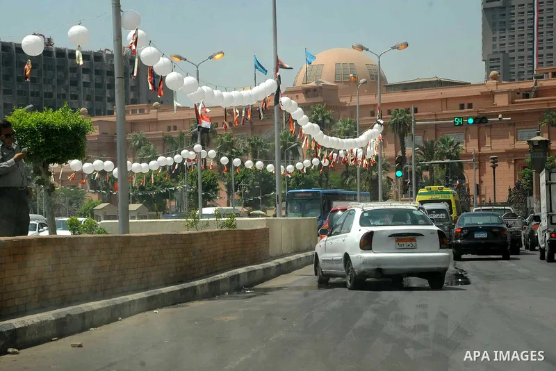 Supporter of Egyptian President Abdel-Fattah el-Sissi celebrate for Thursday's opening of the new extension of the Suez Canal, at Tahrir square, in cairo, Egypt, Thursday, Aug. 6, 2015. Egypt is to unveil a major extensi...