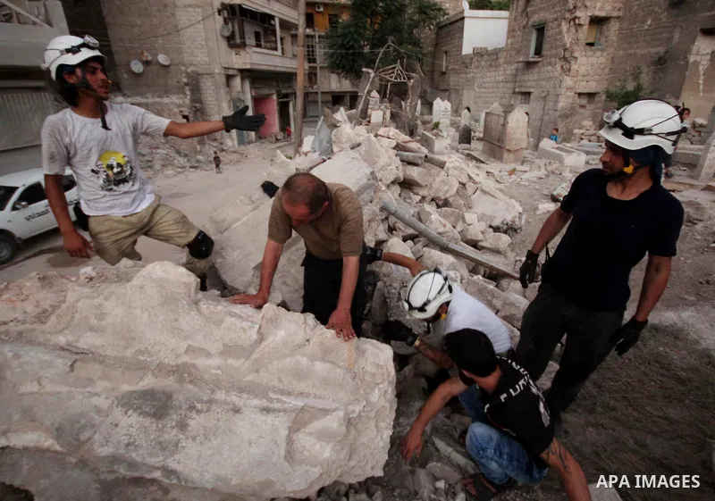 Syrian medics bury a body of 10-month-old baby girl that killed following a shelling attack by forces of Syria's President Bashar al-Assad, in the northern Syrian city of Aleppo, on August 6, 2015. Photo by Ameer al-Halb...
