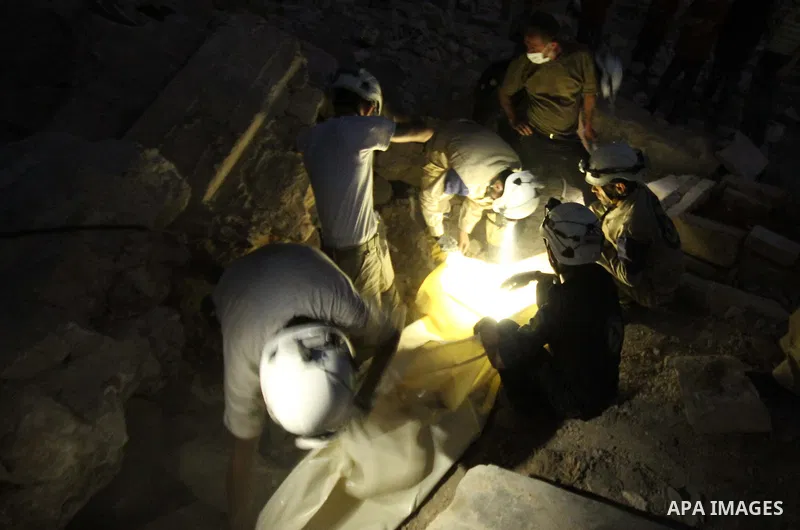 Syrian medics bury a body of 10-month-old baby girl that killed following a shelling attack by forces of Syria's President Bashar al-Assad, in the northern Syrian city of Aleppo, on August 6, 2015. Photo by Ameer al-Halb...