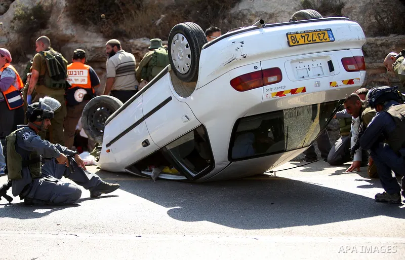 Israeli soldiers inspect a car following a suspected attack by a Palestinian motorist, near the West Bank city of Ramallah on August 6, 2015. Israeli forces shot and injured a Palestinian man on Thursday after a suspecte...