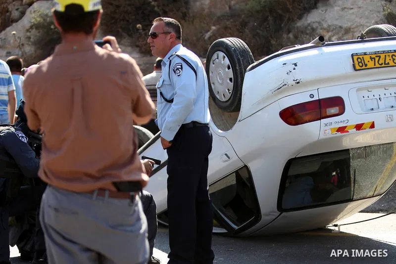 Israeli soldiers inspect a car following a suspected attack by a Palestinian motorist, near the West Bank city of Ramallah on August 6, 2015. Israeli forces shot and injured a Palestinian man on Thursday after a suspecte...