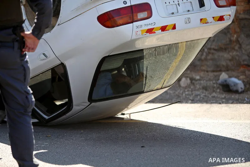 Israeli soldiers inspect a car following a suspected attack by a Palestinian motorist, near the West Bank city of Ramallah on August 6, 2015. Israeli forces shot and injured a Palestinian man on Thursday after a suspecte...