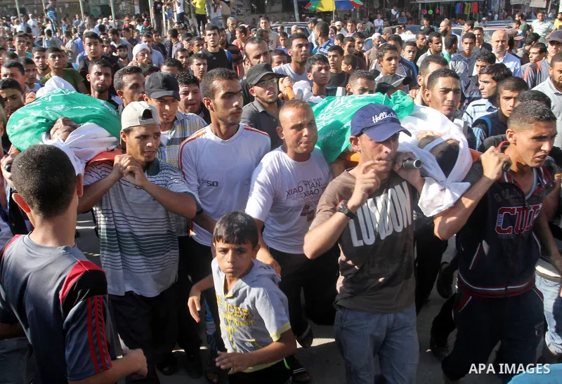 Mourners carry bodies of two of three victims from Abu Nuqeira family, who were killed in an explosion that ripped through a house in the Al-Shabura refugee camp near the southern Gaza Strip town of Rafah, during their f...