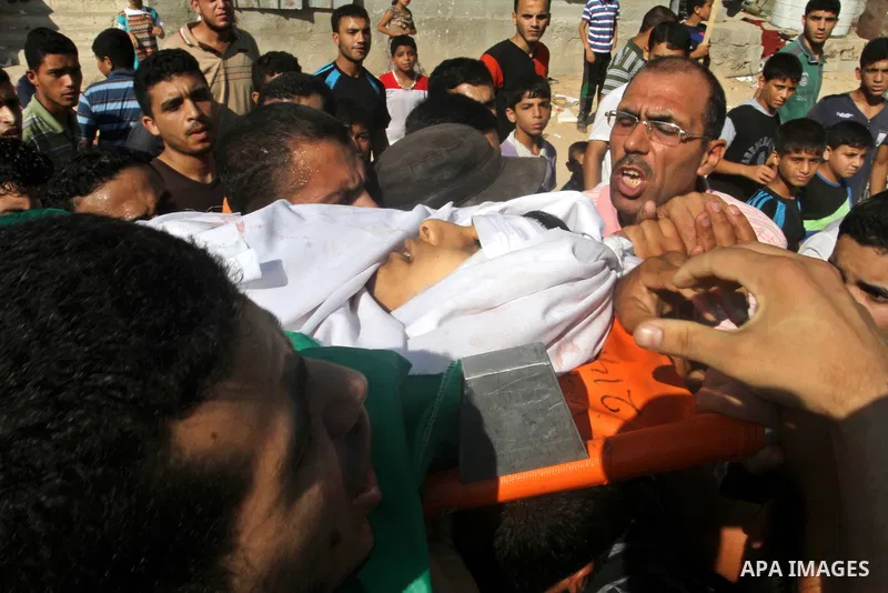 Mourners carry a body of one of three victims from Abu Nuqeira family, who were killed in an explosion that ripped through a house in the Al-Shabura refugee camp near the southern Gaza Strip town of Rafah, during their f...