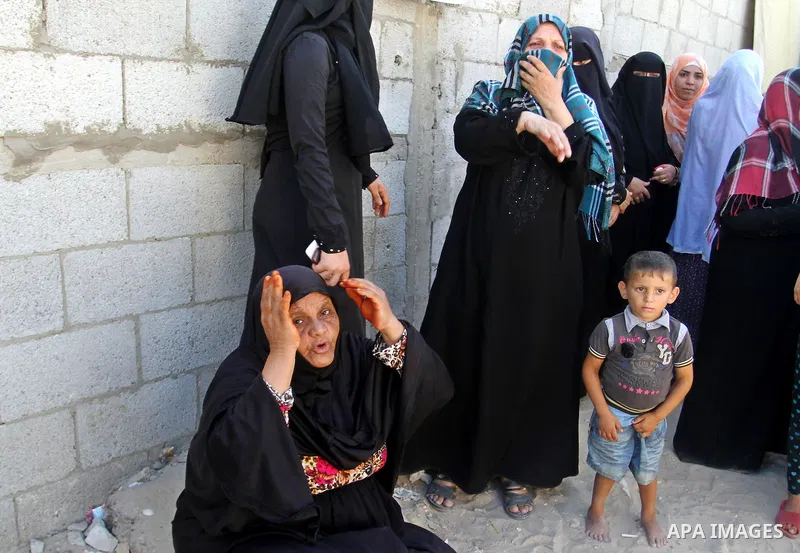 Relatives mourn during the funeral of three victims from Abu Nuqeira family, who were killed in an explosion that ripped through a house in the Al-Shabura refugee camp near the southern Gaza Strip town of Rafah, on Augus...