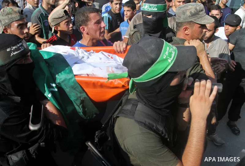 Mourners carry a body of one of three victims from Abu Nuqeira family, who were killed in an explosion that ripped through a house in the Al-Shabura refugee camp near the southern Gaza Strip town of Rafah, during their f...