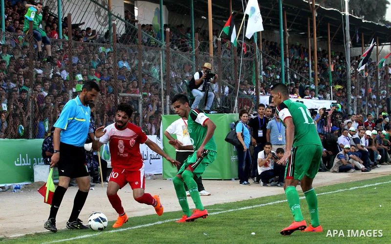 Palestinian Gaza's Shejaya players and Hebron's Al-Ahly players compete during the first leg match of the Palestine Cup final at Yarmuk stadium in Gaza City, on August 6, 2015, as the two teams play each other for the fi...