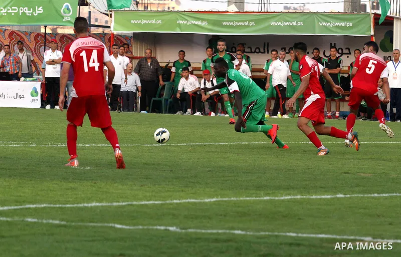 Palestinian Gaza's Shejaya players and Hebron's Al-Ahly players compete during the first leg match of the Palestine Cup final at Yarmuk stadium in Gaza City, on August 6, 2015, as the two teams play each other for the fi...