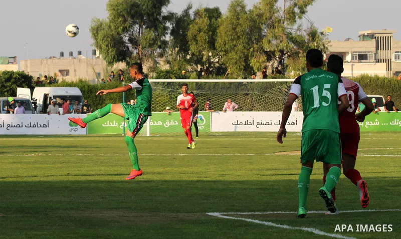 Palestinian Gaza's Shejaya players and Hebron's Al-Ahly players compete during the first leg match of the Palestine Cup final at Yarmuk stadium in Gaza City, on August 6, 2015, as the two teams play each other for the fi...