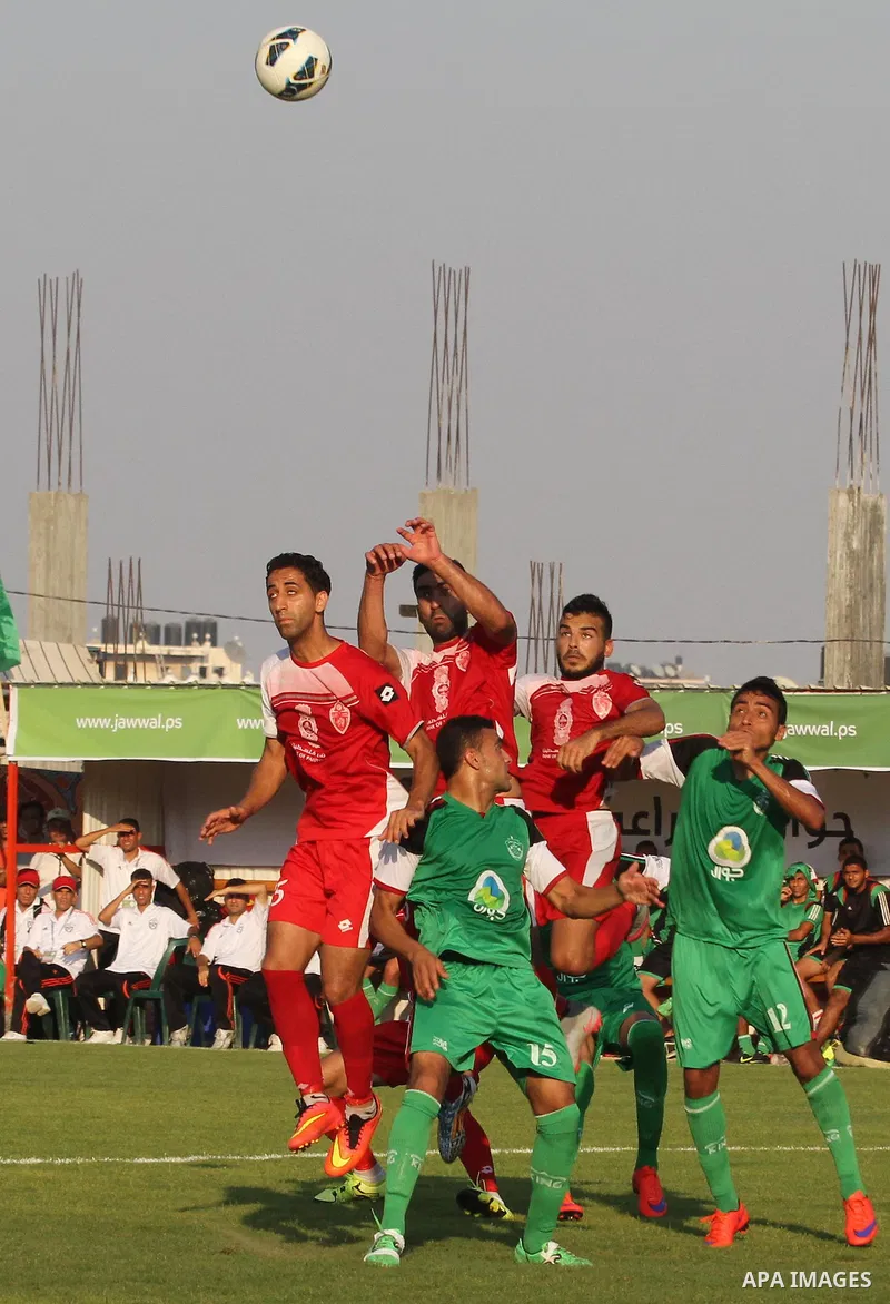 Palestinian Gaza's Shejaya players and Hebron's Al-Ahly players compete during the first leg match of the Palestine Cup final at Yarmuk stadium in Gaza City, on August 6, 2015, as the two teams play each other for the fi...