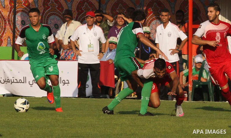 Palestinian Gaza's Shejaya players and Hebron's Al-Ahly players compete during the first leg match of the Palestine Cup final at Yarmuk stadium in Gaza City, on August 6, 2015, as the two teams play each other for the fi...