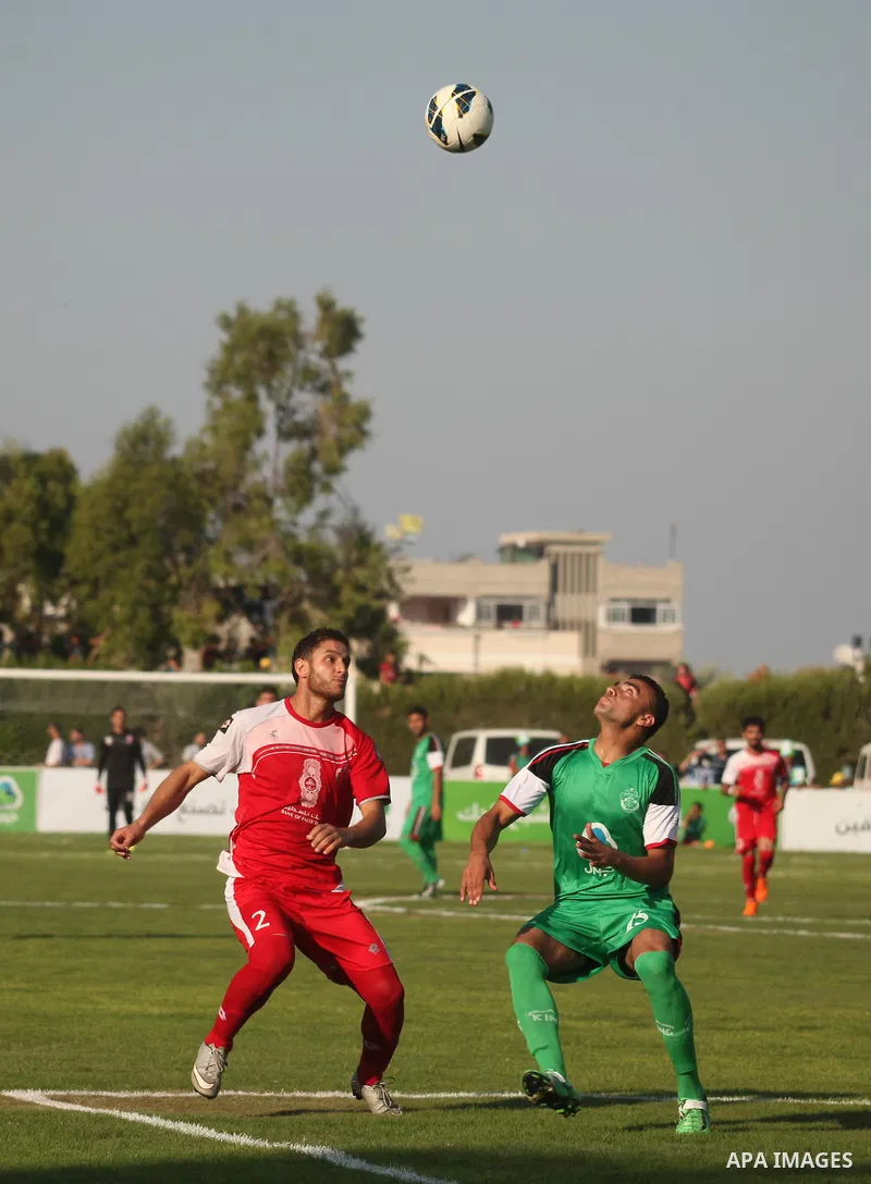 Palestinian Gaza's Shejaya players and Hebron's Al-Ahly players compete during the first leg match of the Palestine Cup final at Yarmuk stadium in Gaza City, on August 6, 2015, as the two teams play each other for the fi...